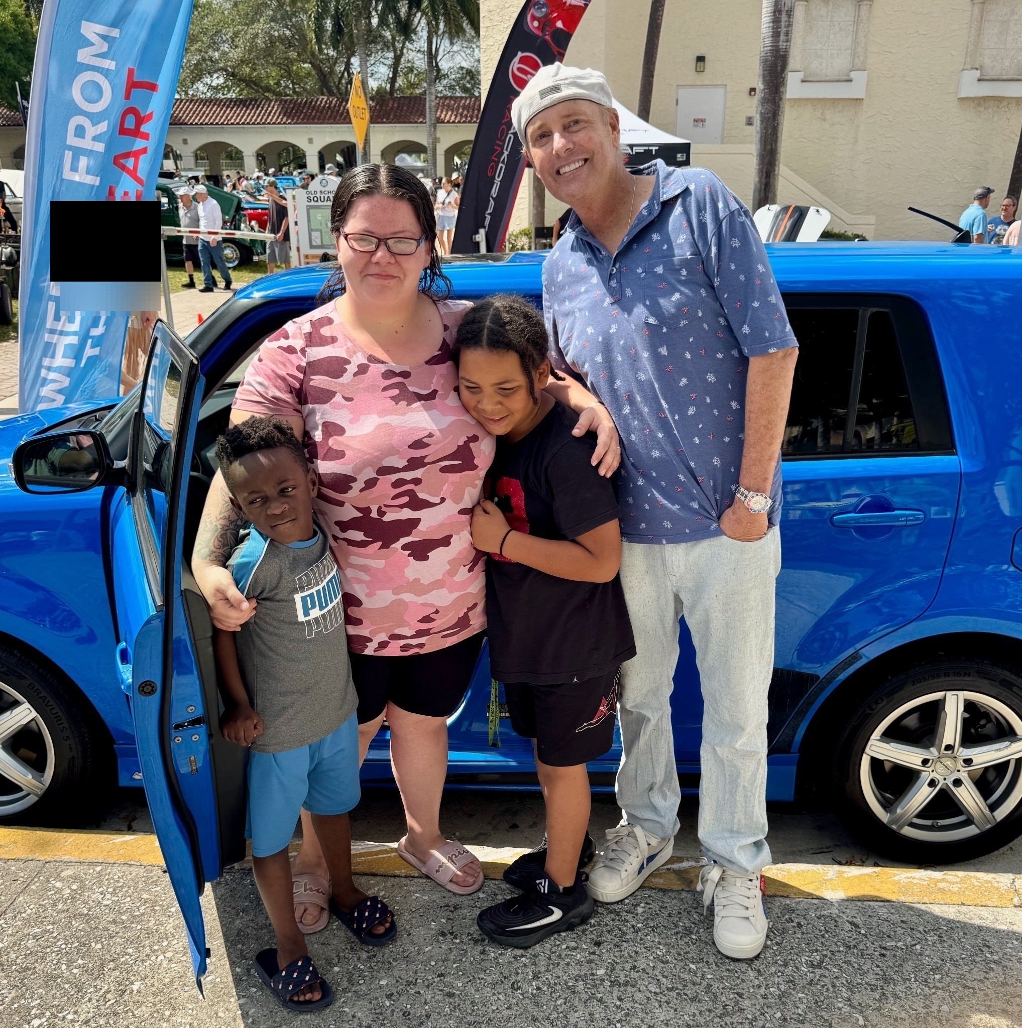 Mother and her children receiving car 199