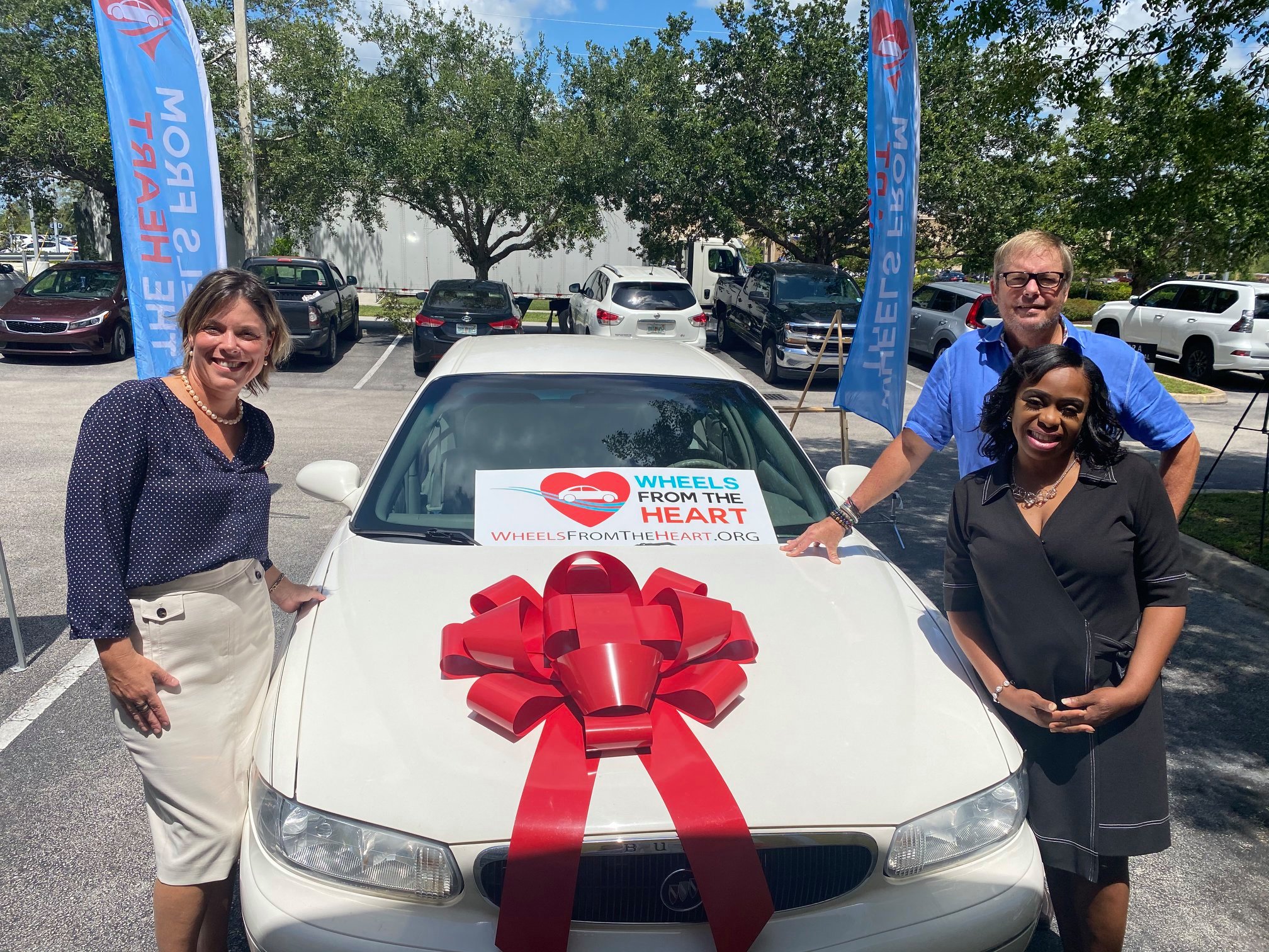Joyful recipient celebrating at vehicle donation ceremony